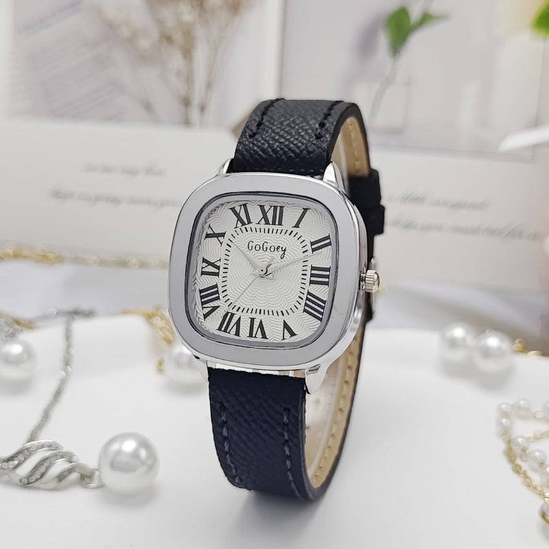 Women’s retro Roman dial leather strap watch with silver case and navy leather strap, close view.