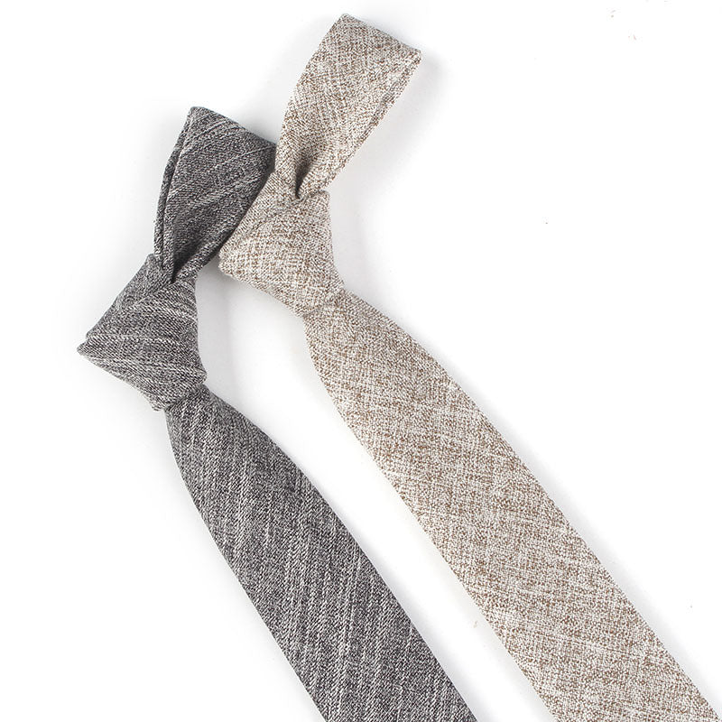 Two knotted hair ties, one gray and one beige, on a white background