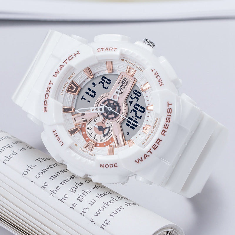 White and rose gold watch on an open book