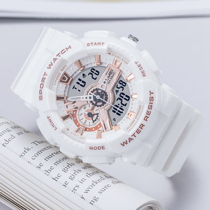White and rose gold watch on an open book