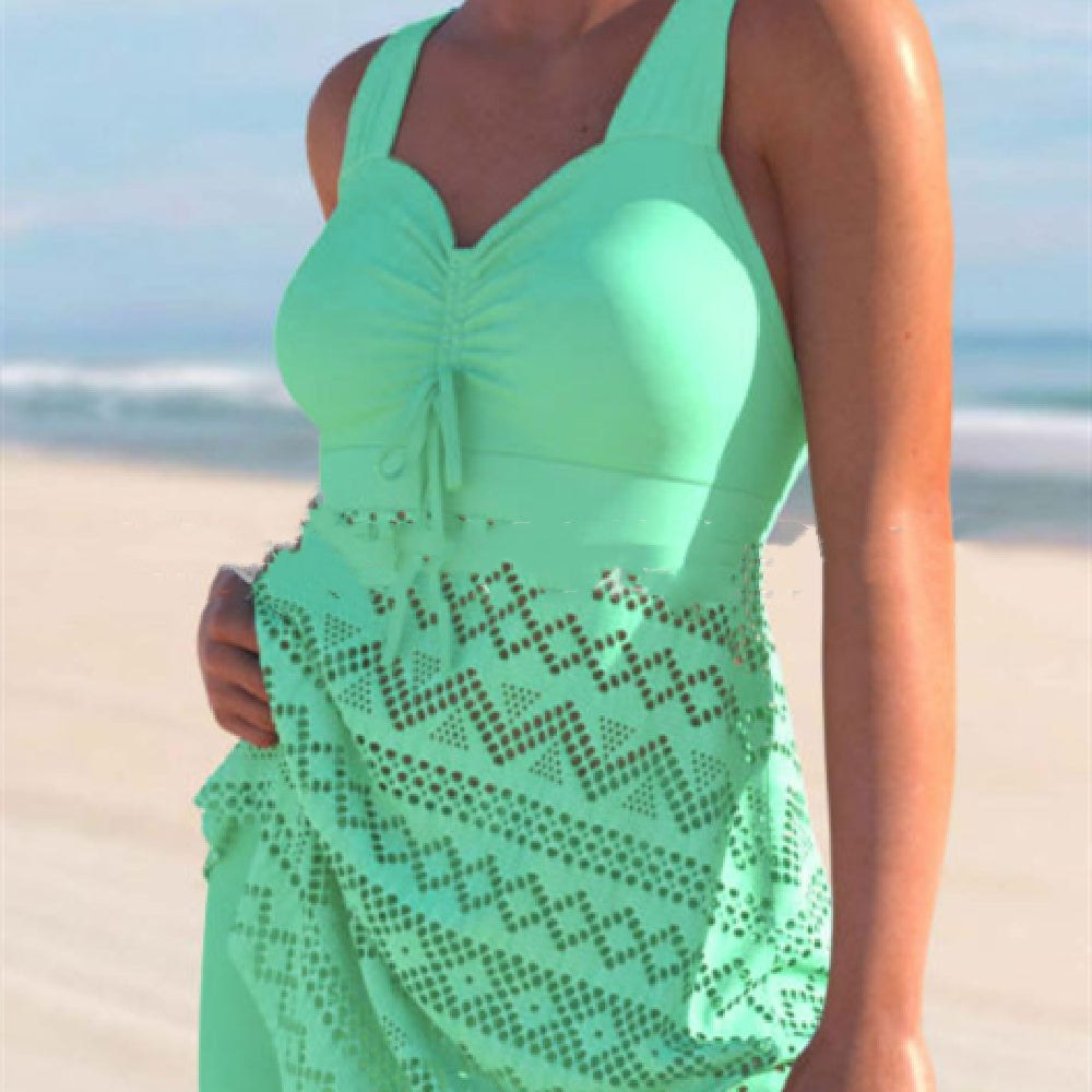 Person wearing a green swimsuit cover-up on a beach