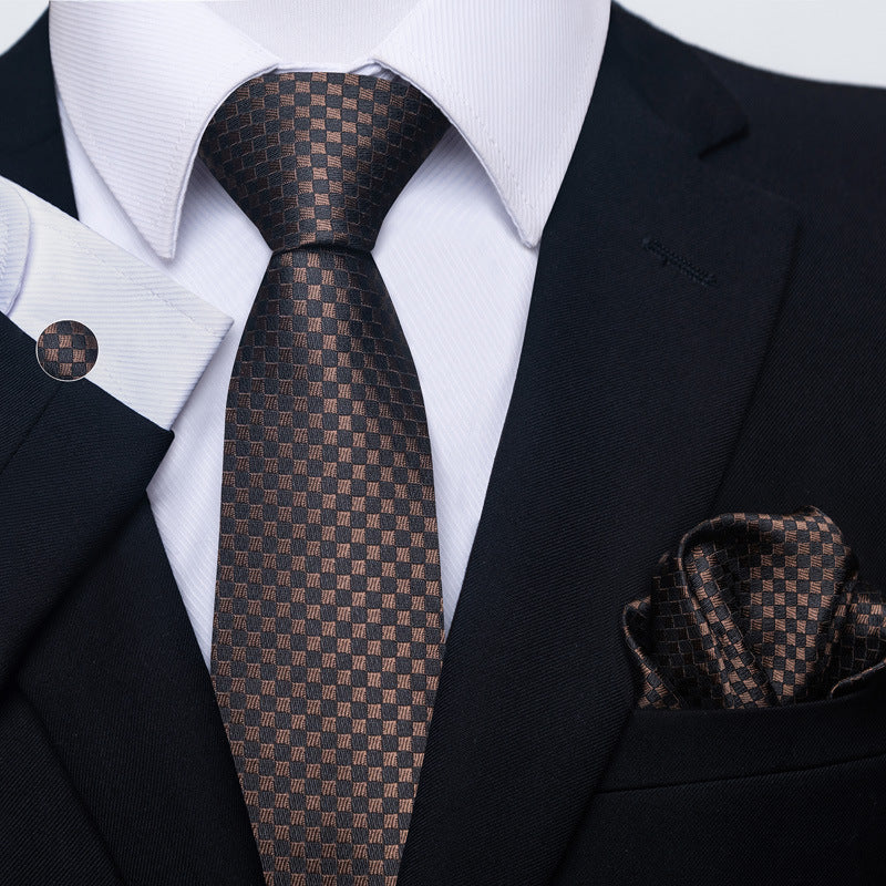 Brown checkered tie and pocket square with a black suit and white shirt.