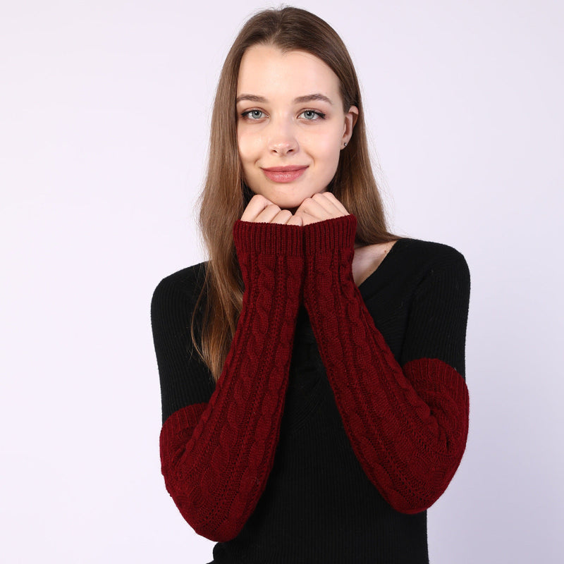 Woman wearing a black and red sweater with red sleeves on a white background