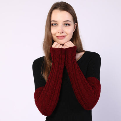 Woman wearing a black and red sweater with red sleeves on a white background