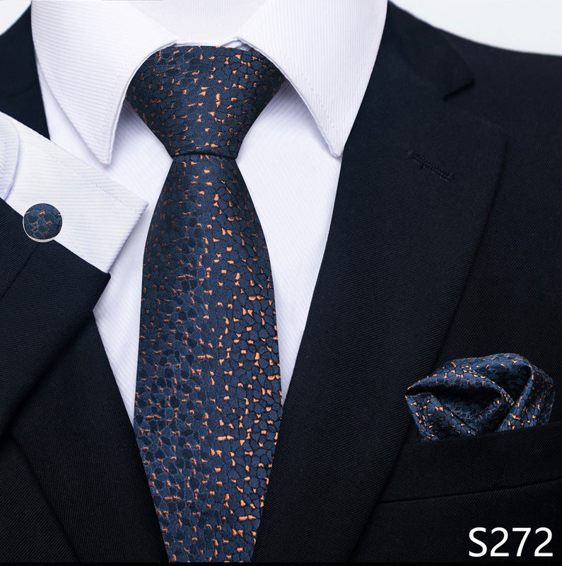 Navy patterned tie with matching pocket square on a suit