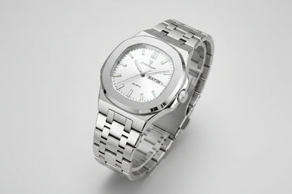 Silver wristwatch with a visible brand tag on a beige background