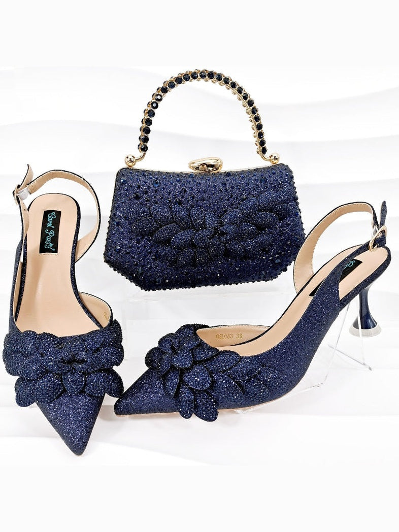 Navy blue glittery high-heeled shoes with matching handbag on a white background