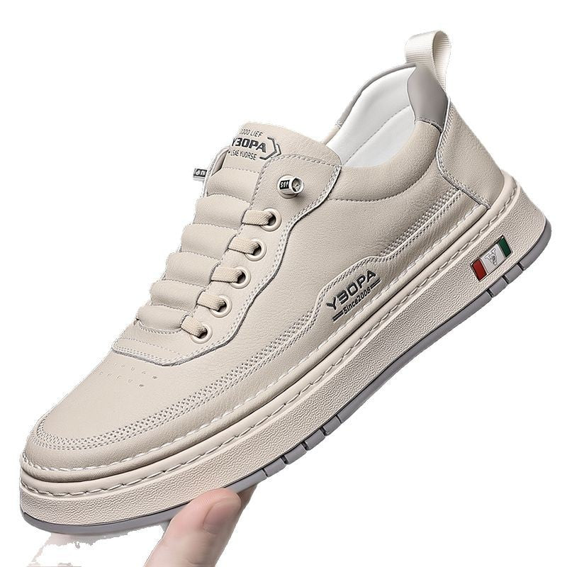 Beige sneaker with brand logo held by a hand on a white background