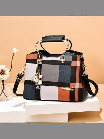 Colorful checkered handbag with decorative elements on a beige background
