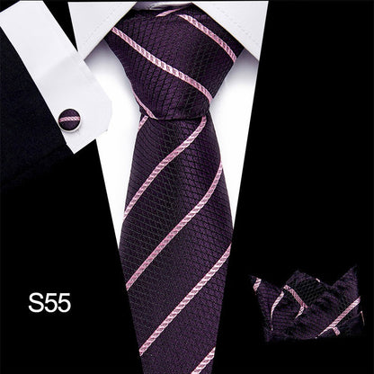 Purple striped tie with matching cufflinks and pocket square on a white shirt.