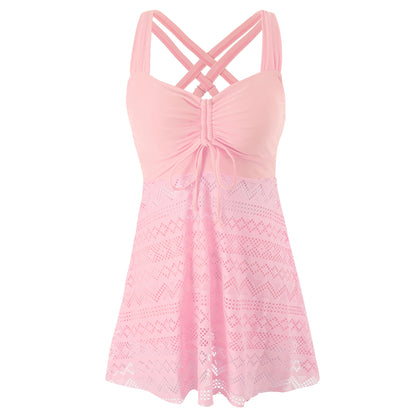 Pink lace dress with criss-cross straps on a white background
