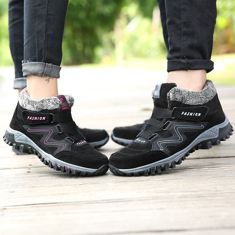 Mid-cut casual sports shoes with thick sole, black pair with fuzzy collars and hook-loop straps.