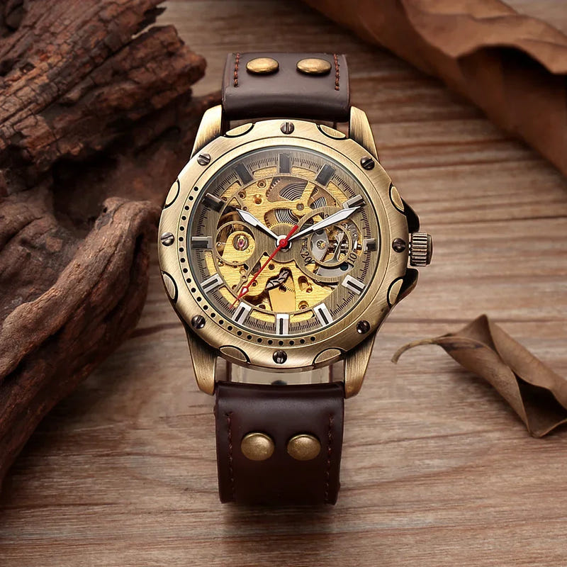 Bronze-tone automatic skeleton watch with gold open-work dial and dark brown leather strap