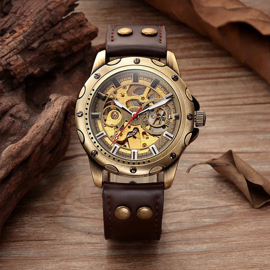 Bronze-tone automatic skeleton watch with gold open-work dial and dark brown leather strap