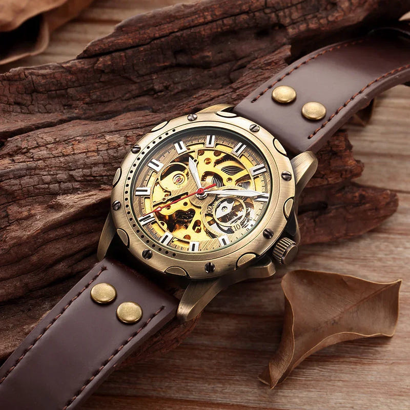 Bronze-tone automatic skeleton watch with gold skeleton dial and dark brown leather strap