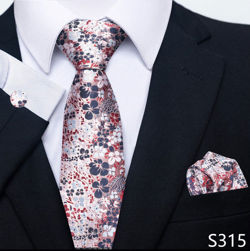 Floral tie and pocket square set with a black suit jacket on a white shirt.