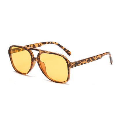 Sunglasses with leopard print frame and yellow lenses on a white background