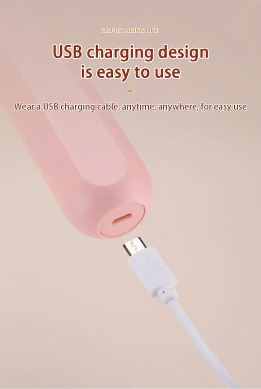 Wireless egg beater charging via USB cable connected to a pink handle