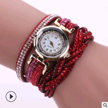 Red wristband with a watch on a wrist against a white background