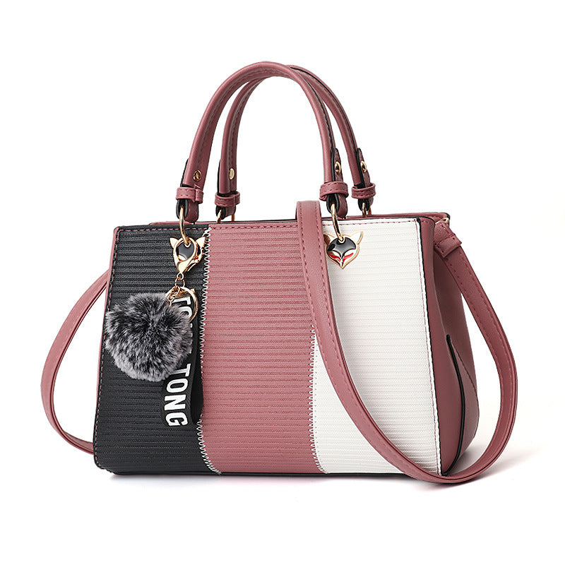 Multicolored handbag with a black section featuring 'TONG' text on a white background