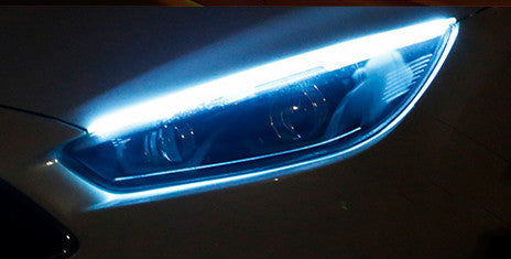Blue LED daytime running light strip with turn-signal glow on car headlamp