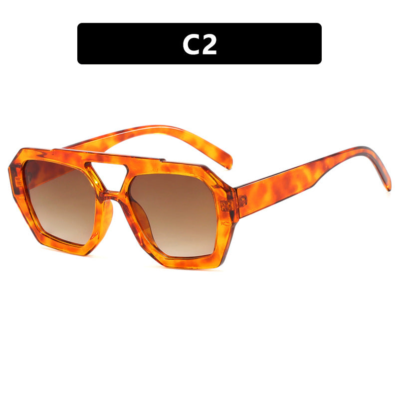 Sunglasses with tortoiseshell frame and brown lenses on a white background