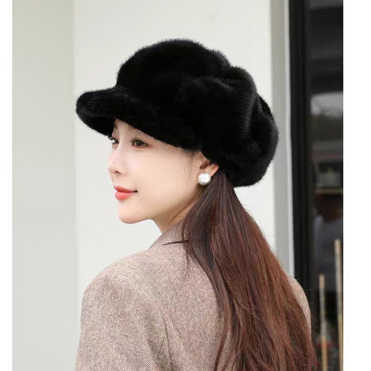Woman wearing a black fur hat with a neutral background