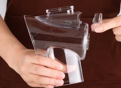 Clear plastic object held by a person against a brown background