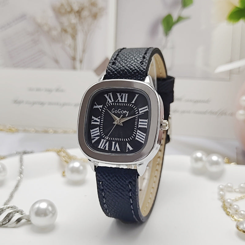 Women’s retro Roman dial leather strap watch with silver case and navy leather strap.