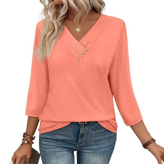 Coral long-sleeve top worn by a person on a white background