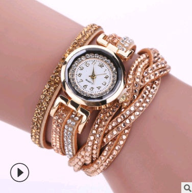 Rose gold bracelet watch on a wrist with a white background
