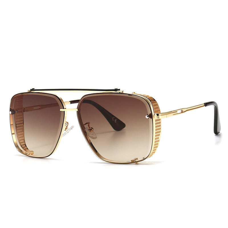 Gold-framed sunglasses with brown gradient lenses on a white background
