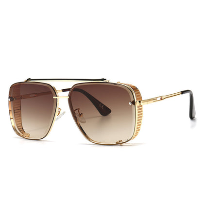 Gold-framed sunglasses with brown gradient lenses on a white background