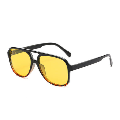 Sunglasses with yellow lenses and black frame on a white background