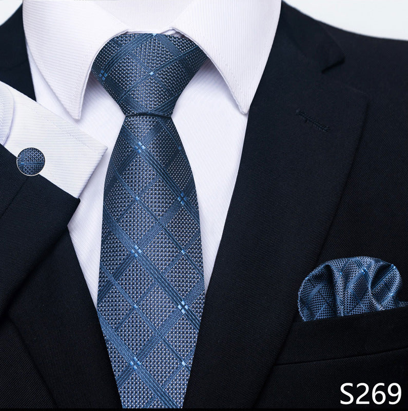 Blue patterned tie and pocket square set with a black suit and white shirt.