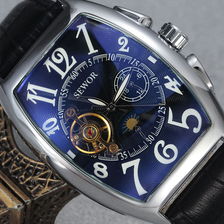 Close-up of a luxury watch with a blue face and visible brand name.