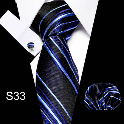Blue and black striped tie with matching pocket square and cufflinks on a white background