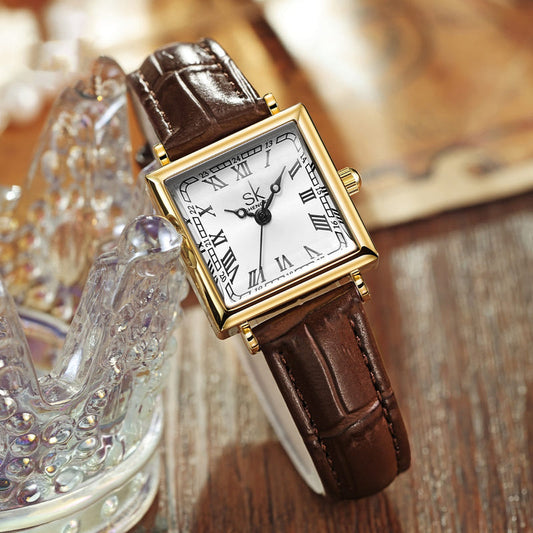 Retro square watch with brown leather strap, gold case, white Roman dial.