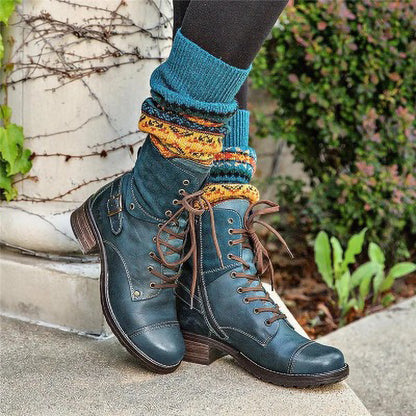 Blue lace-up boots with colorful socks worn outdoors.