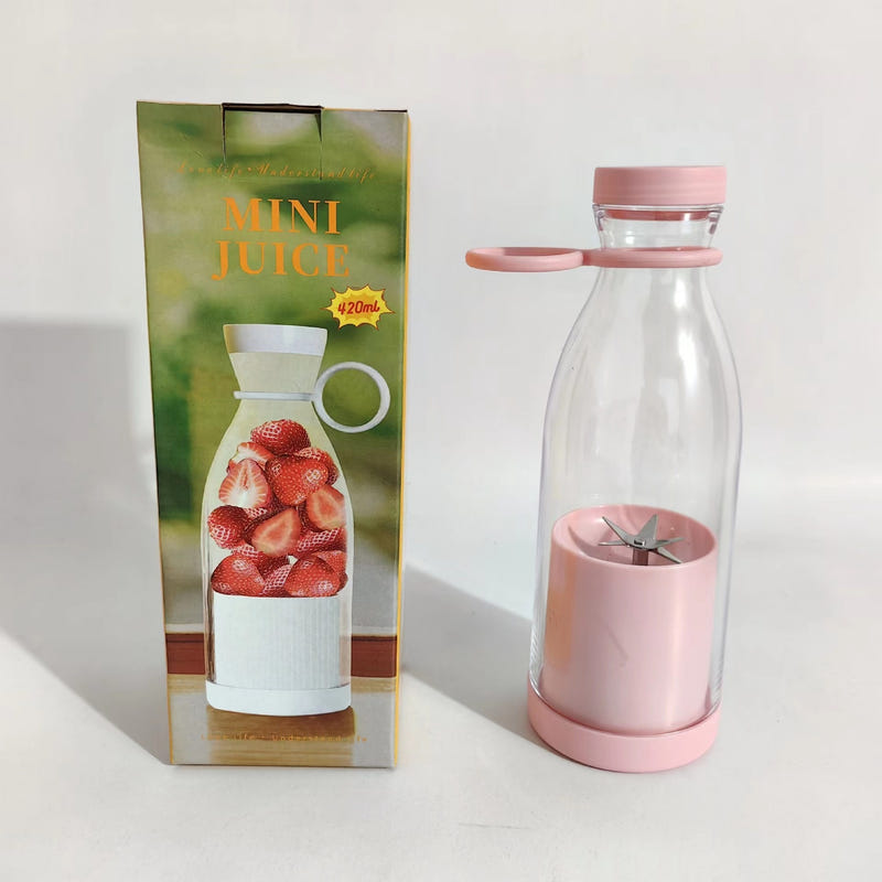 Mini juice blender bottle with pink base and clear cup showing stainless blades