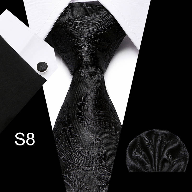 Black paisley tie with matching pocket square on a white background