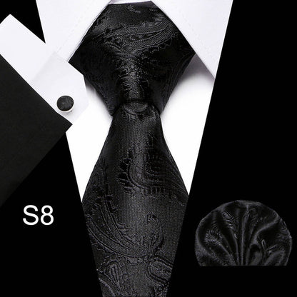 Black paisley tie with matching pocket square on a white background