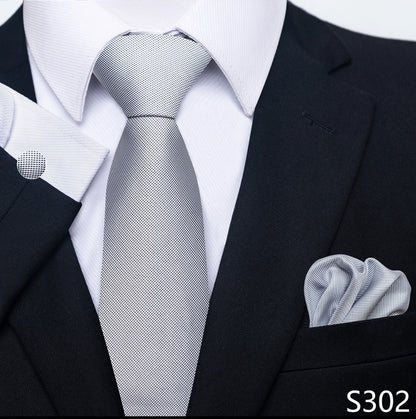 Gray tie and pocket square with a black suit and white shirt