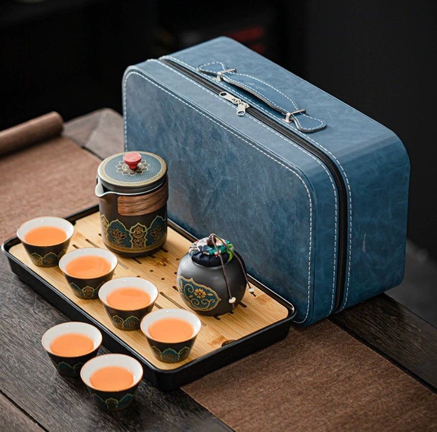 Blue travel case with tea set on a wooden tray