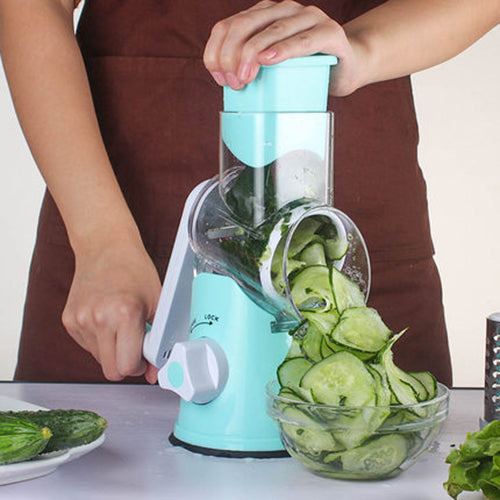 Person using a turquoise manual vegetable spiralizer to create sliced cucumbers.