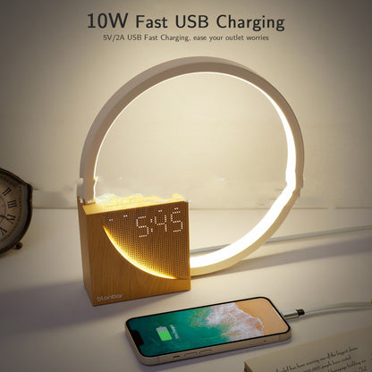 Smart clock with LED ring displaying time, connected to a smartphone for fast USB charging on a white surface.