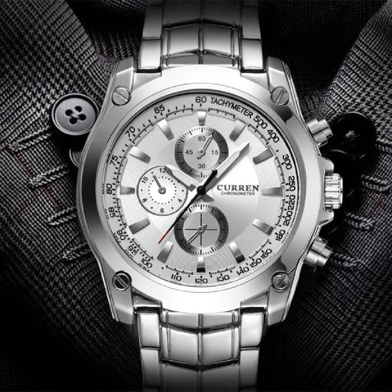 Silver wristwatch with detailed face on a textured black background