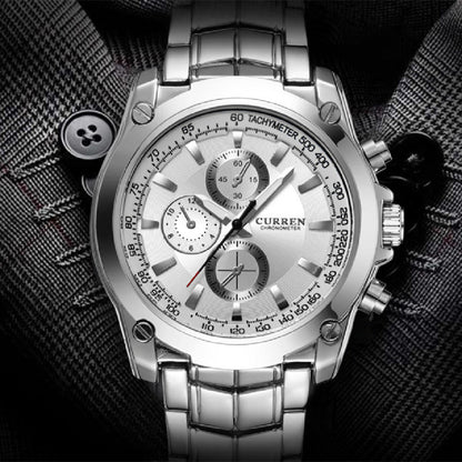 Silver wristwatch with detailed face on a textured black background
