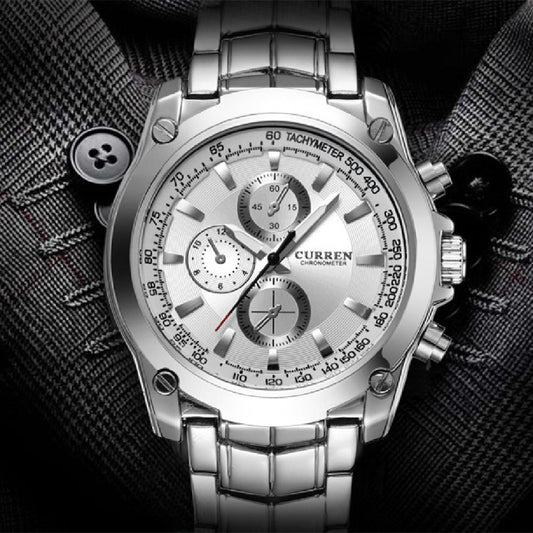 Silver wristwatch with detailed face on a textured black background