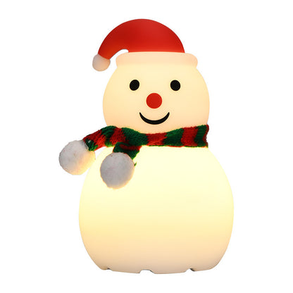 Snowman-shaped night light with a red hat and green scarf on a white background